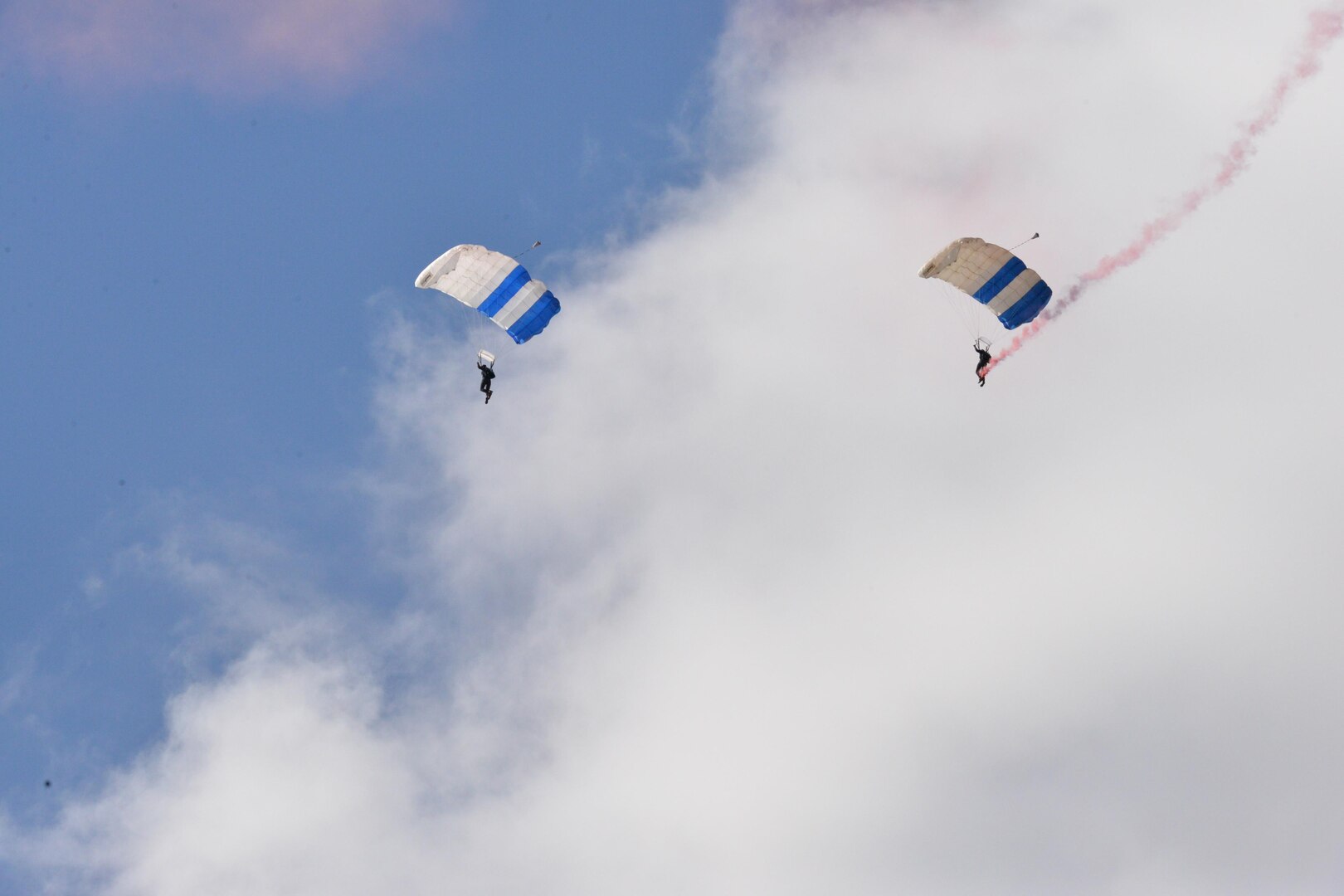 The U.S. Air Force Wings of Blue parachute team perform during the 2015 Air Show and Open House at Joint Base San Antonio-Randolph Oct. 31, 2015. The Wings of Blue has both a demonstration team and a competition team. The demonstration team travels across the country to airshows, sporting events, and other venues to represent the Air Force in precision parachuting.  (U.S. Air Force photo by Olivia Mendoza/released)

