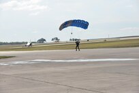 A member of the U.S. Air Force Wings of Blue parachute team lands during the 2015 Air Show and Open House at Joint Base San Antonio-Randolph Oct. 31, 2015. The Wings of Blue has both a demonstration team and a competition team. The demonstration team travels across the country to airshows, sporting events, and other venues to represent the Air Force in precision parachuting.  (U.S. Air Force photo by Olivia Mendoza/released)
