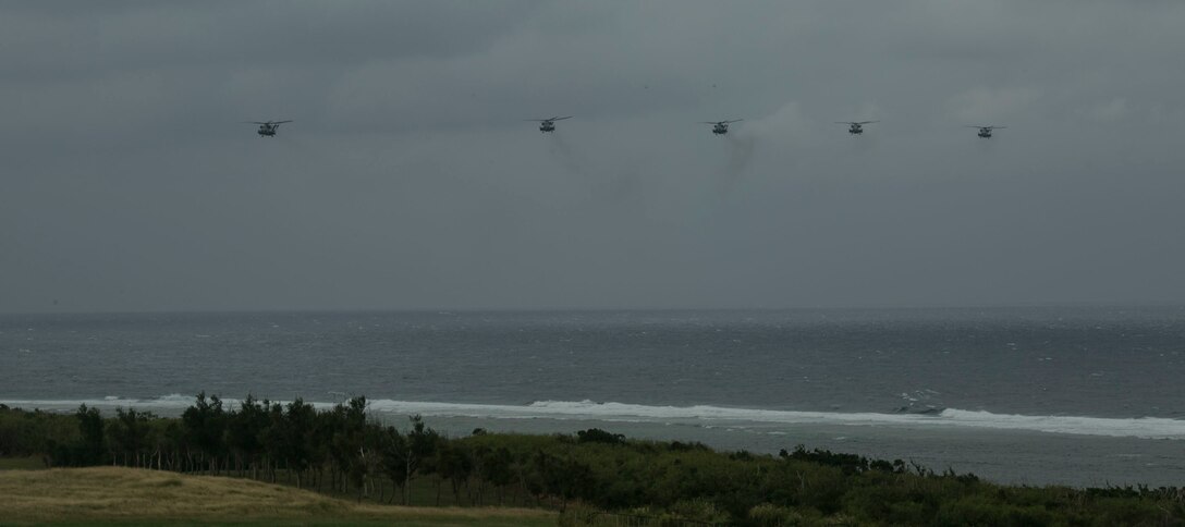 Five CH-53E Super Stallions fly into Ie Shima, Okinawa, Japan, carrying Marines for a regimental air assault as part of exercise Blue Chromite 2016, Oct. 31, 2015. Blue Chromite is an amphibious exercise conducted by Marines in the ground, logistics and air combat elements of III Marine Expeditionary Force. The Super Stallions are with Marine Heavy Helicopter Squadron 462, Marine Air Group 16, 2nd Marine Aircraft Wing, II Marine Expeditionary Force, currently attached to MAG 36, 1st MAW, III MEF, under the unit deployment program. The Marines aboard the aircraft are with 1st Battalion, 2nd Marine Regiment, 2nd Marine Division, II MEF, currently under the command of 4th Marines, 3rd MarDiv, III MEF, as part of the unit deployment program. (U.S. Marine Corps photo by Cpl. William Hester/ Released)