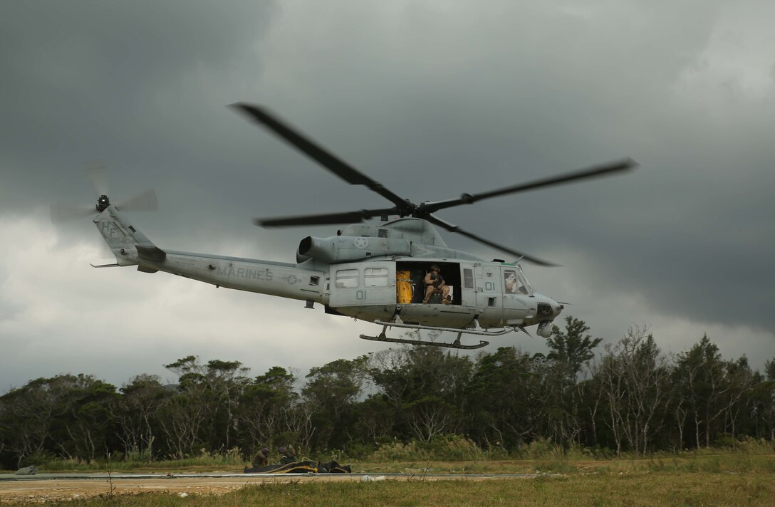 A UH-1Y Huey takes off from a forward armament and refueling point during Blue Chromite, in Landing Zone Phoenix, Camp Schwab, Okinawa, Japan, Oct. 31, 2015.  Marines with Marine Wing Support Squadron 172, Marine Air Group 36, 1st Marine Aircraft Wing, III Marine Expeditionary Force, executed a FARP to provide aircraft also supporting Blue Chromite with fuel to continue defending the ground element of the Marine Air Ground Task Force.  Blue Chromite is a large-scale amphibious exercise that draws primarily from III MEF training resources on Okinawa. The location of the training allows participating units to maintain a forward-deployed posture and eliminates the cost of traveling to train. (U.S. Marine Corps Photo by Cpl. Natalie A. Dillon/Released)