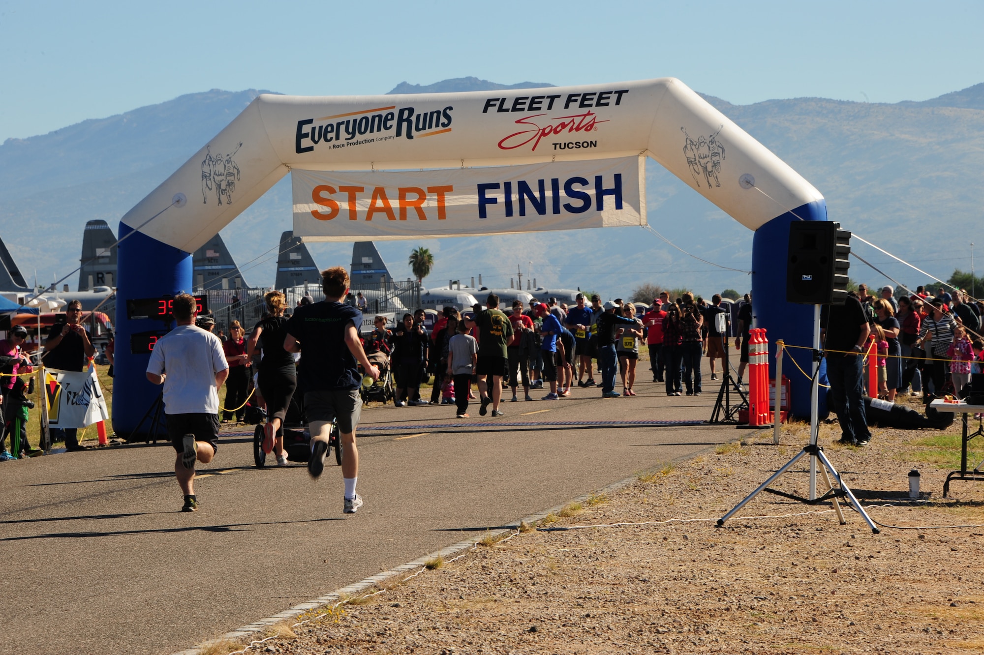 Participants of the Desert Boneyard 10K Run & 5K Run/Walk race towards the finish line at the 309th Aerospace Maintenance and Regeneration Group, Davis-Monthan Air Force Base, Ariz., Oct. 31, 2015. More than 1,000 service members and Tucson community members registered for this event. (U.S. Air Force photo by Airman Basic Nathan H. Barbour/Released)