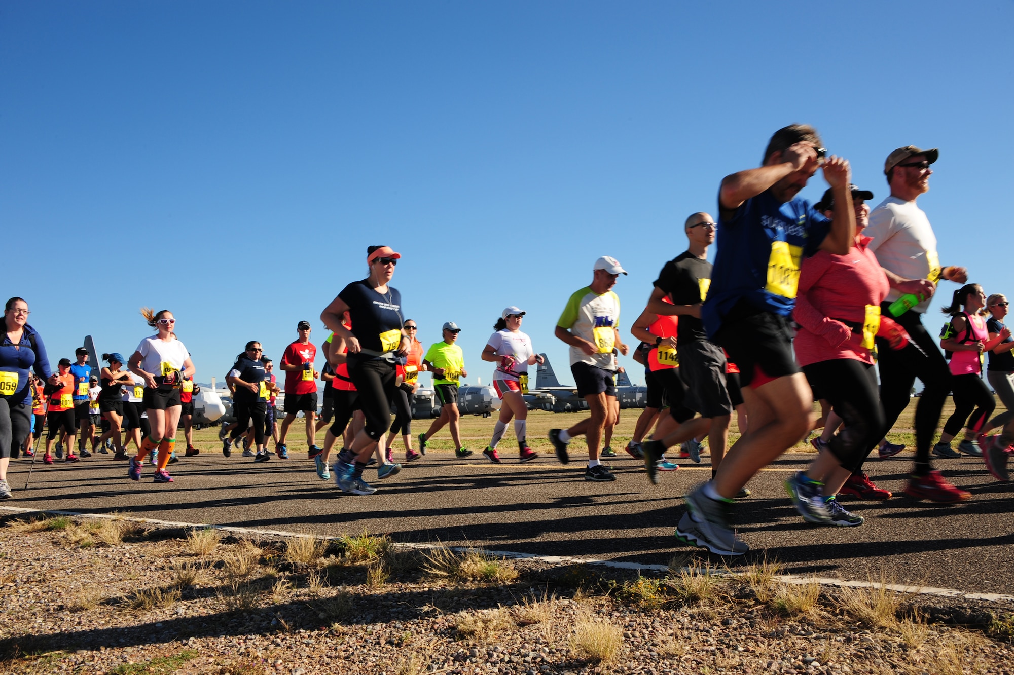 Participants of the Desert Boneyard 10K Run & 5K Run/Walk run past historic aircraft at the 309th Aerospace Maintenance and Regeneration Group at Davis-Monthan Air Force Base, Ariz., Oct. 31, 2015. 309th AMARG is a specialized facility that provides critical maintenance and regeneration capabilities for support of the U.S. Department of Defense, allied war-fighters and other government agencies. (U.S. Air Force photo by Airman Basic Nathan H. Barbour/Released)