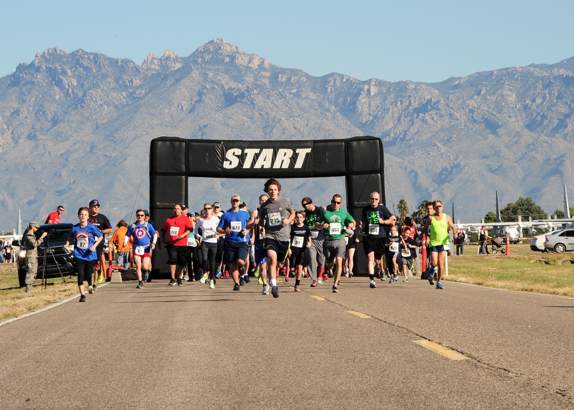 Participants begin the Desert Boneyard 10K Run & 5K Run/Walk at the 309th Aerospace Maintenance and Regeneration Group, Davis-Monthan Air Force Base, Ariz., Oct. 31, 2015. This event gave the general public a rare opportunity to access a site usually only available to authorized personnel and guided bus tours. (U.S. Air Force photo by Airman Basic Nathan H. Barbour/Released)