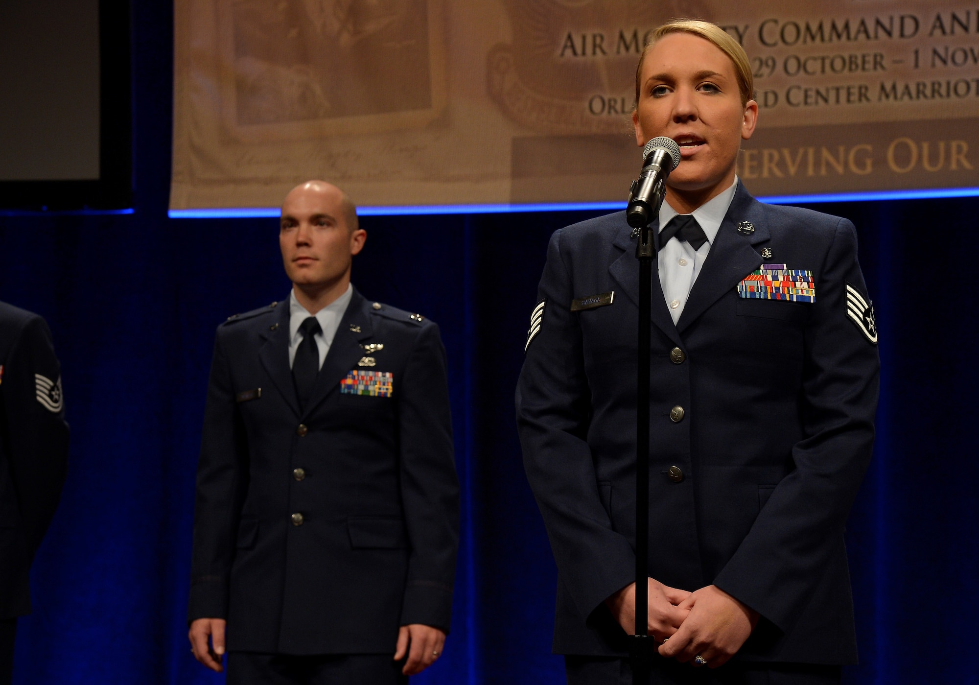 Staff Sgt. Taylor Savage, a combat medic, introduces herself during the 47th Annual Airlift Tanker Association Convention and Technology Exposition and A/TA and AMC Symposium in Orlando, Fla., Oct. 31, 2015. Savage was injured in 2013 by an improvised explosive device in Afghanistan, while supporting Army partners. (U.S. Air Force photo by Staff Sgt. Shandresha Mitchell/Released)