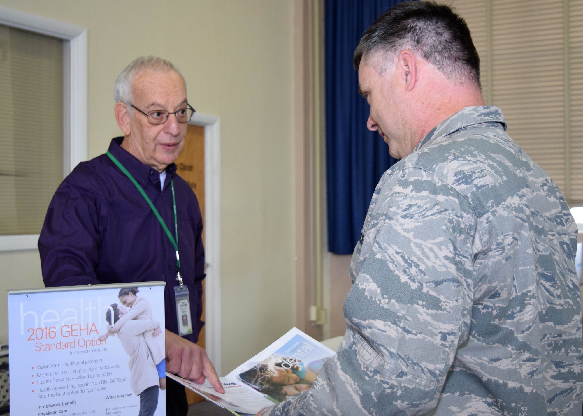 Representatives from a variety of government health care insurers gathered at the Horsham Air Guard Station, Horsham, Pennsylvania, Oct. 29,2015 during a health fair for civilian government employees and military technicians. Maj. Bennie Roberson, 111th Attack Wing inspector general, shown right, discusses healthcare options with Sid Severe, contract representative with Government Employee Health Association. (U.S. Air National Guard photo by Master Sgt. Christopher Botzum/Released)
