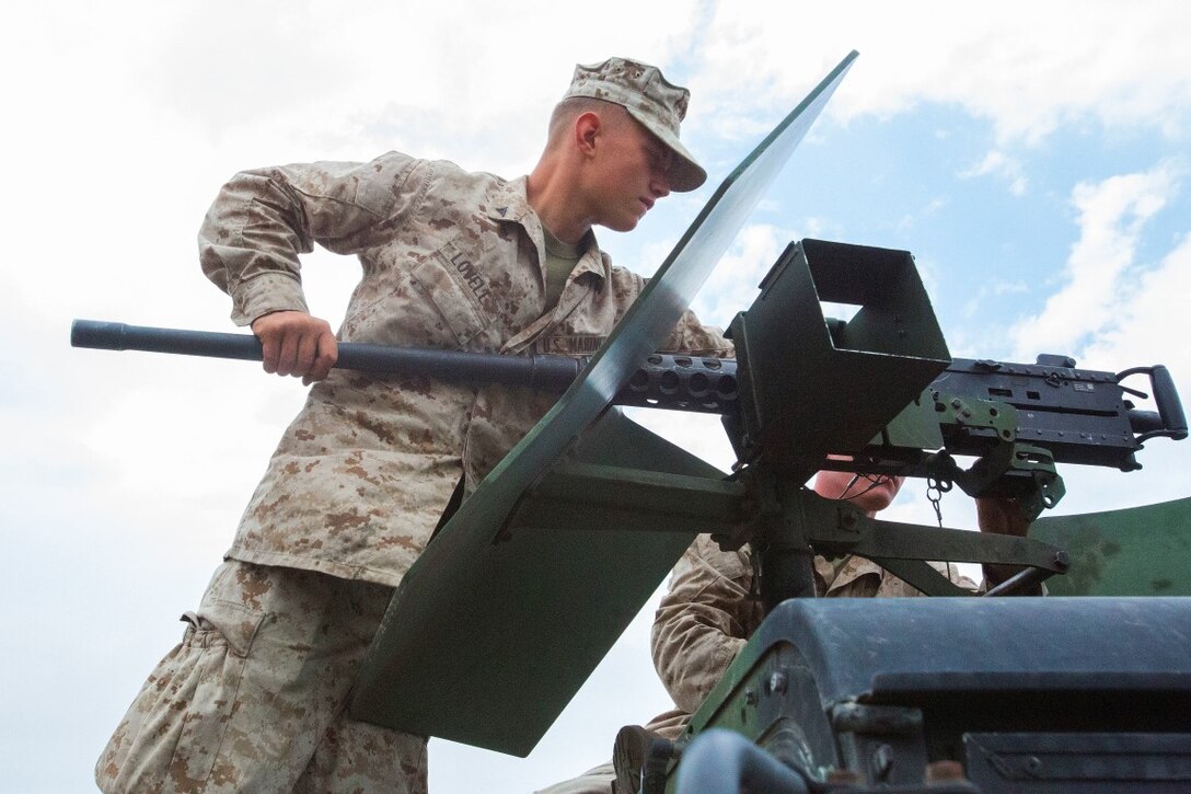 Lance Cpl. Jacob Lovell, a gunner with 3rd Low Altitude Air Defense Battalion, Marine Air Control Group 38, 3rd Marine Aircraft Wing, attaches the gun barrel to an M2 .50 caliber machine during a convoy air-defense exercise aboard Marine Corps Base Camp Pendleton, Calif., Aug. 25, 2015. The exercise gave the Marines the opportunity to work with a simulated enemy aircraft, an AH-1Z Cobra helicopter provided by Marine Light Attack Helicopter Squadron 169, Marine Aircraft Group 39, 3rd MAW. Realistic training allows Marines to remain effective in increasingly complex environments around the world. (U.S. Marine Corps photo by Lance Cpl. Caitlin Bevel)
