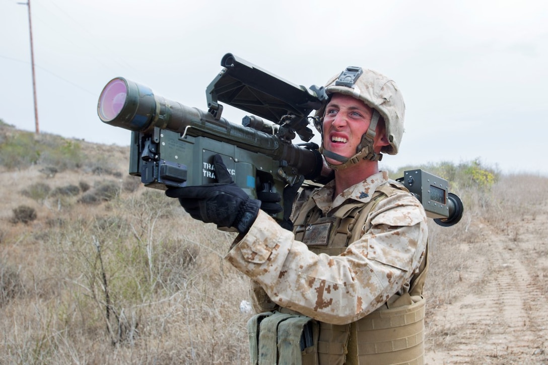 Corporal John Graham, a gunner with 3rd Low Altitude Air Defense Battalion, Marine Air Control Group 38, 3rd Marine Aircraft Wing, aims a dummy FIM-92 anti-aircraft weapon during a convoy air-defense exercise aboard Marine Corps Base Camp Pendleton, Calif., Aug. 25, 2015. The exercise gave the Marines the opportunity to work with a simulated enemy aircraft, an AH-1Z Cobra helicopter provided by Marine Light Attack Helicopter Squadron 169, Marine Aircraft Group 39, 3rd MAW. Realistic training allows Marines to remain effective in increasingly complex environments around the world. (U.S. Marine Corps photo by Lance Cpl. Caitlin Bevel)