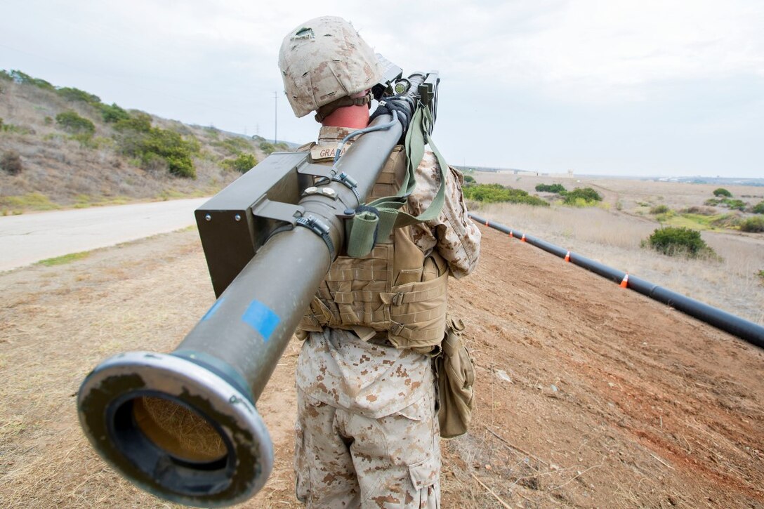 Corporal John Graham, a gunner with 3rd Low Altitude Air Defense Battalion, Marine Air Control Group 38, 3rd Marine Aircraft Wing, aims a dummy FIM-92 anti-aircraft weapon during a convoy air-defense exercise aboard Marine Corps Base Camp Pendleton, Calif., Aug. 25, 2015. The exercise gave the Marines the opportunity to work with a simulated enemy aircraft, an AH-1Z Cobra helicopter provided by Marine Light Attack Helicopter Squadron 169, Marine Aircraft Group 39, 3rd MAW. Realistic training allows Marines to remain effective in increasingly complex environments around the world. (U.S. Marine Corps photo by Lance Cpl. Caitlin Bevel)