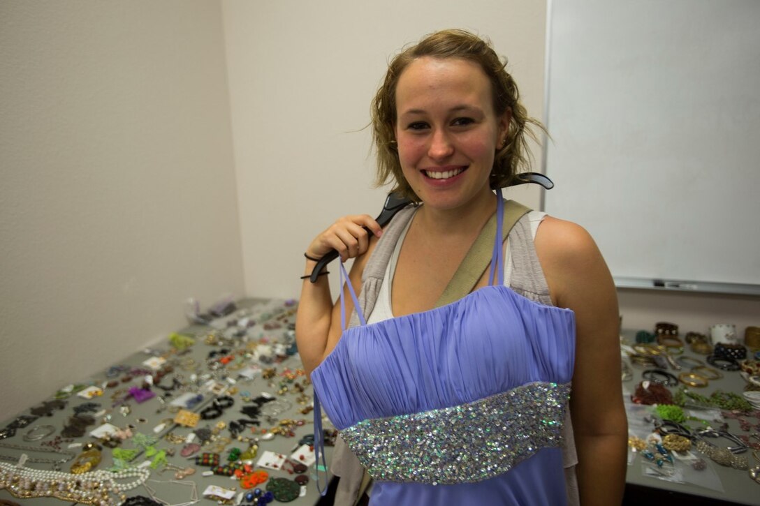 Courtney Moody, wife of Lance Cpl. Justin Moody, an assaultman with 2nd Battalion, 5th Marine Regiment, 1st Marine Division, I Marine Expeditionary Force, shops for a dress during the ball gown giveaway organized by the family readiness officers of 5th Marine Regiment, at Marine Corps Base Camp Pendleton, Calif., Aug. 22, 2015. Approximately 2,000 dresses, shoes and accessories were donated to the event where more than 150 wives and family members of Marines were able to choose outfits for the Marine Corps birthday ball.