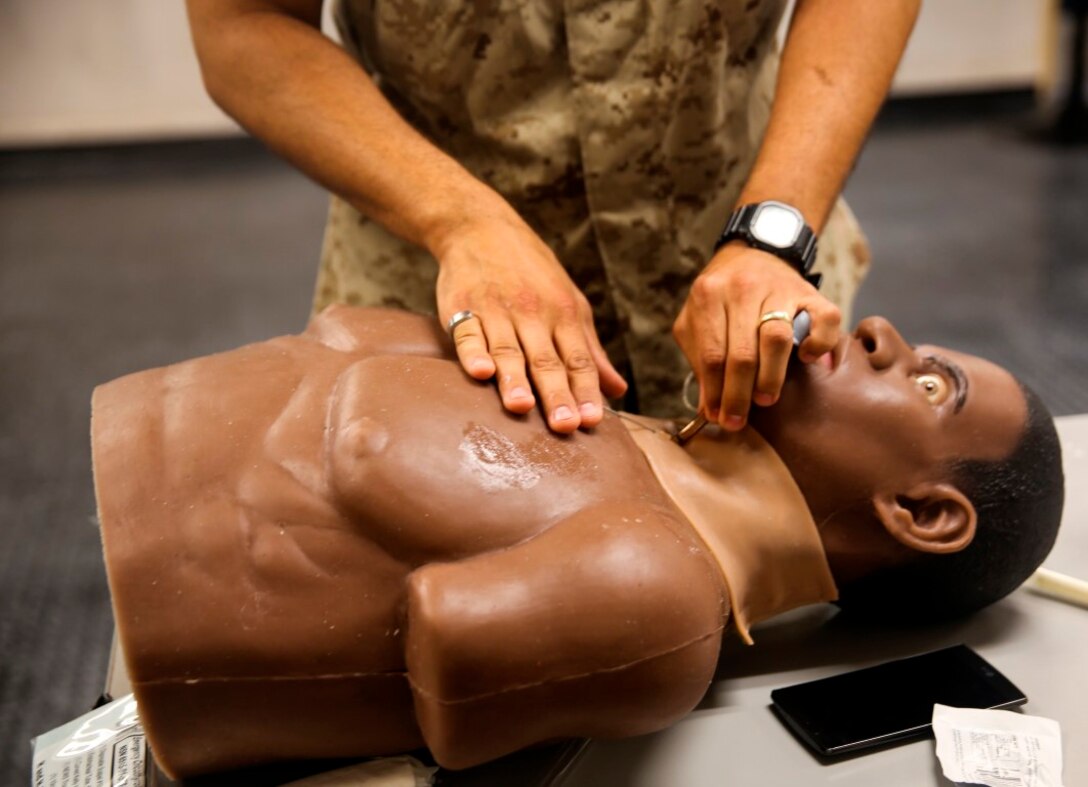 A corpsman with Field Medical Training Battalion West learns to perform an emergency cricothyroidotomy to re-establish a functioning airway on a simulated wounded victim during the Field Medical Service Technician Course aboard Marine Corps Base Camp Pendleton, Calif., Aug. 18, 2015. The course is an 8-week period of instruction that includes classwork, intense physical training and practical application of field medical techniques. (Photo by Pvt. Robert Bliss/Released)