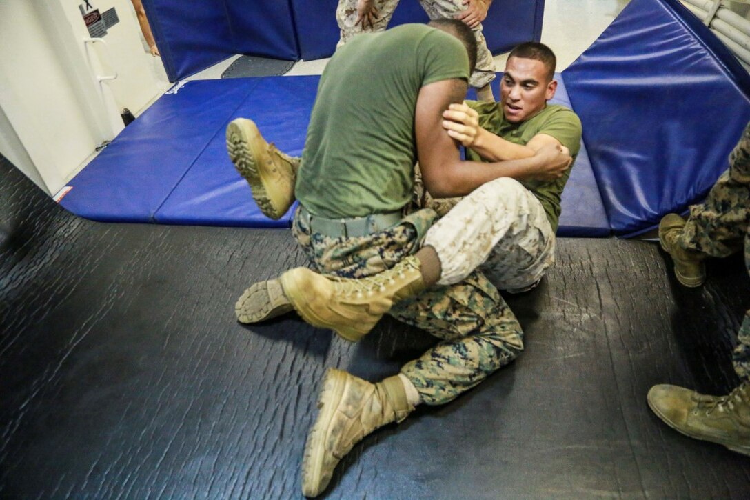 GULF OF ADEN (Aug. 28, 2015) U.S. Marine Cpl. Jose Martinez, right, grapples with Lance Cpl. Jordan Jiles during a Marine Corps martial arts program green belt course aboard the amphibious transport dock ship USS Anchorage (LPD 23). Martinez is an administrative clerk with Combat Logistics Battalion 15, and Jiles is a food service specialist with Headquarters and Service Company, Battalion Landing Team 3rd Battalion, 1st Marine Regiment, 15th Marine Expeditionary Unit.  The 15th MEU is embarked on the Essex Amphibious Ready Group and deployed in support of maritime security operations and theater security cooperation efforts in the U.S. 5th Fleet area of operations. (U.S. Marine Corps photo by Sgt. Steve H. Lopez/Released)