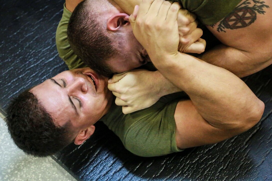 GULF OF ADEN (Aug. 28, 2015) U.S. Marine Sgt. Raymond Rodriguez, left, grapples with Lance Cpl. Thiago Desousa during a Marine Corps martial arts program green belt course aboard the amphibious transport dock ship USS Anchorage (LPD 23). Rodriguez is a motor transport operator with Combat Logistics Battalion 15, and Desousa is a motor transport operator with Headquarters and Service Company, Battalion Landing Team 3rd Battalion, 1st Marine Regiment, 15th Marine Expeditionary Unit.  The 15th MEU is embarked on the Essex Amphibious Ready Group and deployed in support of maritime security operations and theater security cooperation efforts in the U.S. 5th Fleet area of operations. (U.S. Marine Corps photo by Sgt. Steve H. Lopez/Released)