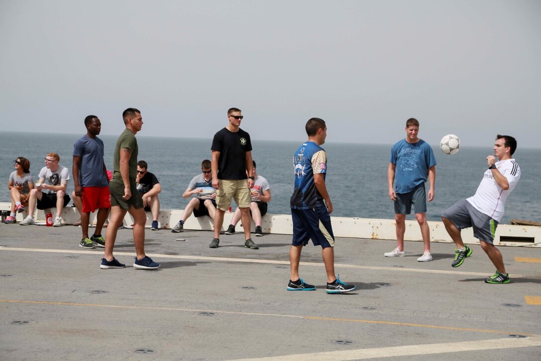GULF OF ADEN (Aug. 29, 2015) U.S. Marines and Sailors from the 15th Marine Expeditionary Unit and Essex Amphibious Ready Group play soccer during a steel beach picnic aboard the amphibious transport dock ship USS Anchorage (LPD 23). Elements of the 15th MEU are embarked aboard the Anchorage, which is part of the ESX ARG, and is deployed in support of maritime security operations and theater security cooperation efforts in the U.S. 5th Fleet area of operations. (U.S. Marine Corps photo by Sgt. Steve H. Lopez/Released)
