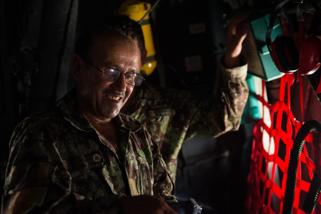 An Afghan airman inspects aircrew flight equipment aboard an Afghan C-130H Hercules aircraft during a training session with U.S. Airmen from the 455th Air Expeditionary Wing at Hamid Karzai International Airport, Kabul, Afghanistan, Aug. 29, 2015. Airmen with the 455th AEW visited Forward Operating Base Oqab and Hamid Karzai International Airport to share their aircrew flight equipment knowledge with their Afghan counterparts and also assist Train, Advice, Assist Command-Air with keeping Coalition AFE equipment current. (U.S. Air Force photo by Tech. Sgt. Joseph Swafford/Released)