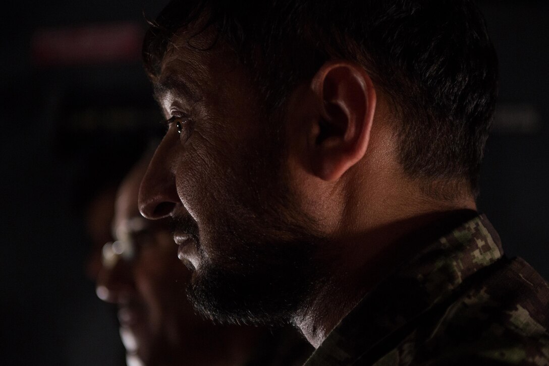 An Afghan airman listens during a training session aboard an Afghan C-130H Hercules aircraft with U.S. Airmen from the 455th Air Expeditionary Wing at Hamid Karzai International Airport, Kabul, Afghanistan, Aug. 29, 2015. Airmen with the 455th AEW visited Forward Operating Base Oqab and Hamid Karzai International Airport to share their aircrew flight equipment knowledge with their Afghan counterparts and also assist Train, Advice, Assist Command-Air with keeping Coalition AFE equipment current. (U.S. Air Force photo by Tech. Sgt. Joseph Swafford/Released)