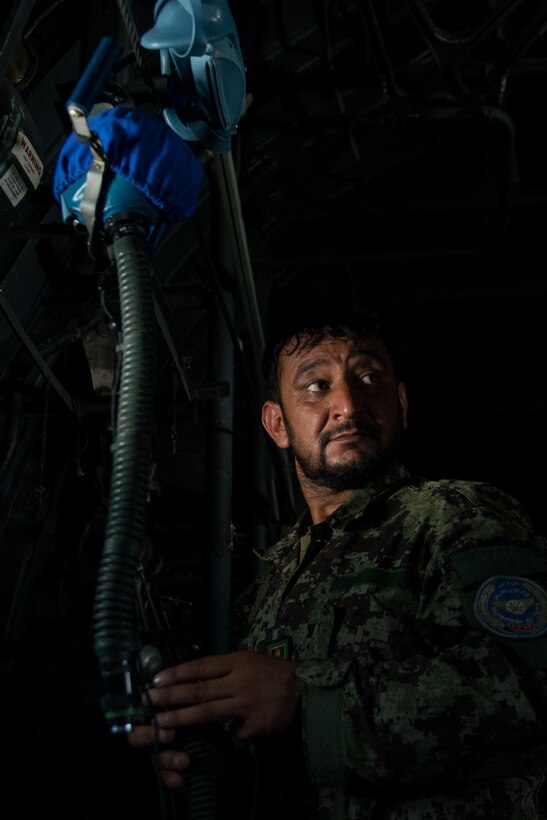 An Afghan airman inspects aircrew flight equipment aboard an Afghan C-130H Hercules aircraft during a training session with U.S. Airmen from the 455th Air Expeditionary Wing at Hamid Karzai International Airport, Kabul, Afghanistan, Aug. 29, 2015. Airmen with the 455th AEW visited Forward Operating Base Oqab and Hamid Karzai International Airport to share their aircrew flight equipment knowledge with their Afghan counterparts and also assist Train, Advice, Assist Command-Air with keeping Coalition AFE equipment current. (U.S. Air Force photo by Tech. Sgt. Joseph Swafford/Released)