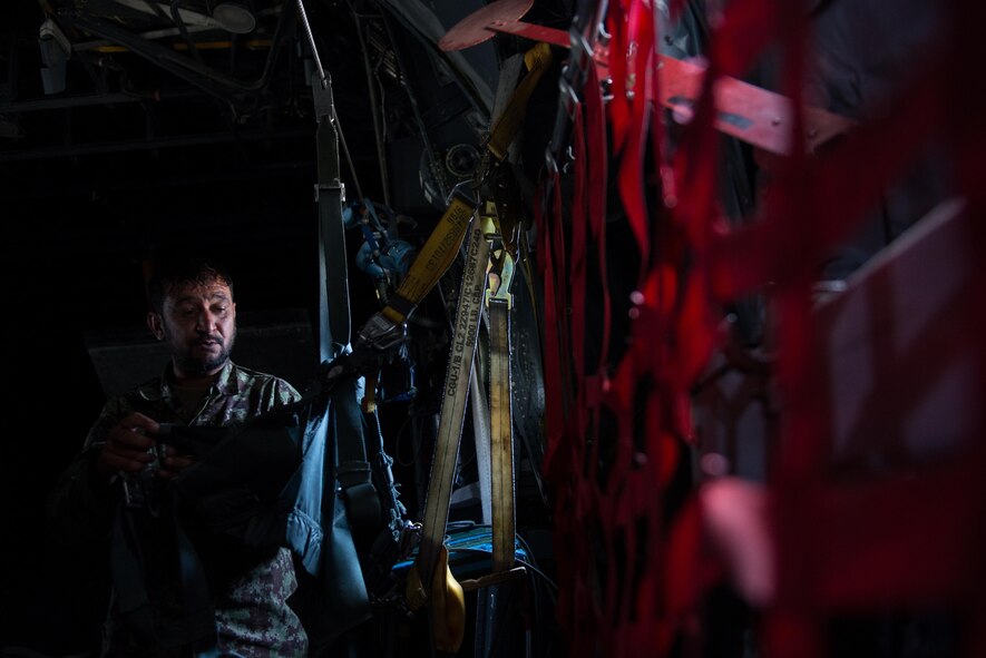 An Afghan airman inspects aircrew flight equipment aboard an Afghanistan air force C-130H Hercules during a training session with U.S. Airmen from the 455th Air Expeditionary Wing at Hamid Karzai International Airport, Afghanistan, Aug. 29, 2015. Airmen with the 455th AEW visited Forward Operating Base Oqab and Hamid Karzai International Airport to share their AFE knowledge with their Afghan counterparts and also assist TAAC-Air with keeping coalition AFE equipment current. (U.S. Air Force photo/Tech. Sgt. Joseph Swafford)