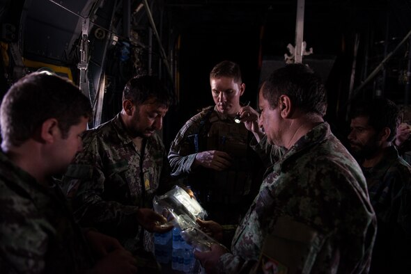 U.S. Air Force Master Sgt. Michael Doane, the Train, Advice, Assist Command-Air flight equipment adviser and operations team superintendent (center), and Afghan airmen complete an AFE inspection during a training session with U.S. Airmen from the 455th Air Expeditionary Wing at Hamid Karzai International Airport, Afghanistan, Aug. 29, 2015. Airmen with the 455th AEW visited Forward Operating Base Oqab and Hamid Karzai International Airport to share their AFE knowledge with their Afghan counterparts and also assist TAAC-Air with keeping coalition AFE equipment current.  (U.S. Air Force photo/Tech. Sgt. Joseph Swafford)