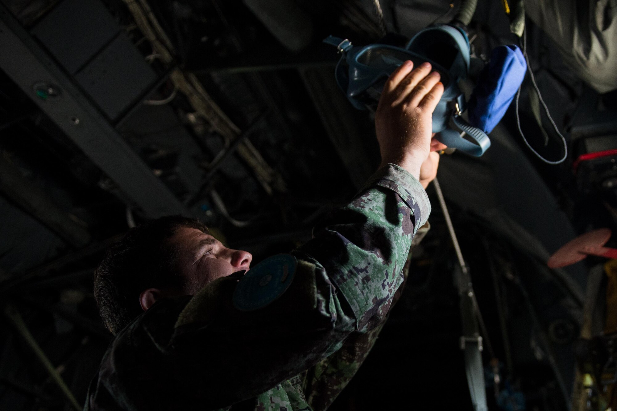 An Afghan airman inspects aircrew flight equipment aboard an Afghan C-130H Hercules aircraft during a training session with U.S. Airmen from the 455th Air Expeditionary Wing at Hamid Karzai International Airport, Kabul, Afghanistan, Aug. 29, 2015. Airmen with the 455th AEW visited Forward Operating Base Oqab and Hamid Karzai International Airport to share their aircrew flight equipment knowledge with their Afghan counterparts and also assist Train, Advice, Assist Command-Air with keeping Coalition AFE equipment current. (U.S. Air Force photo by Tech. Sgt. Joseph Swafford/Released) 