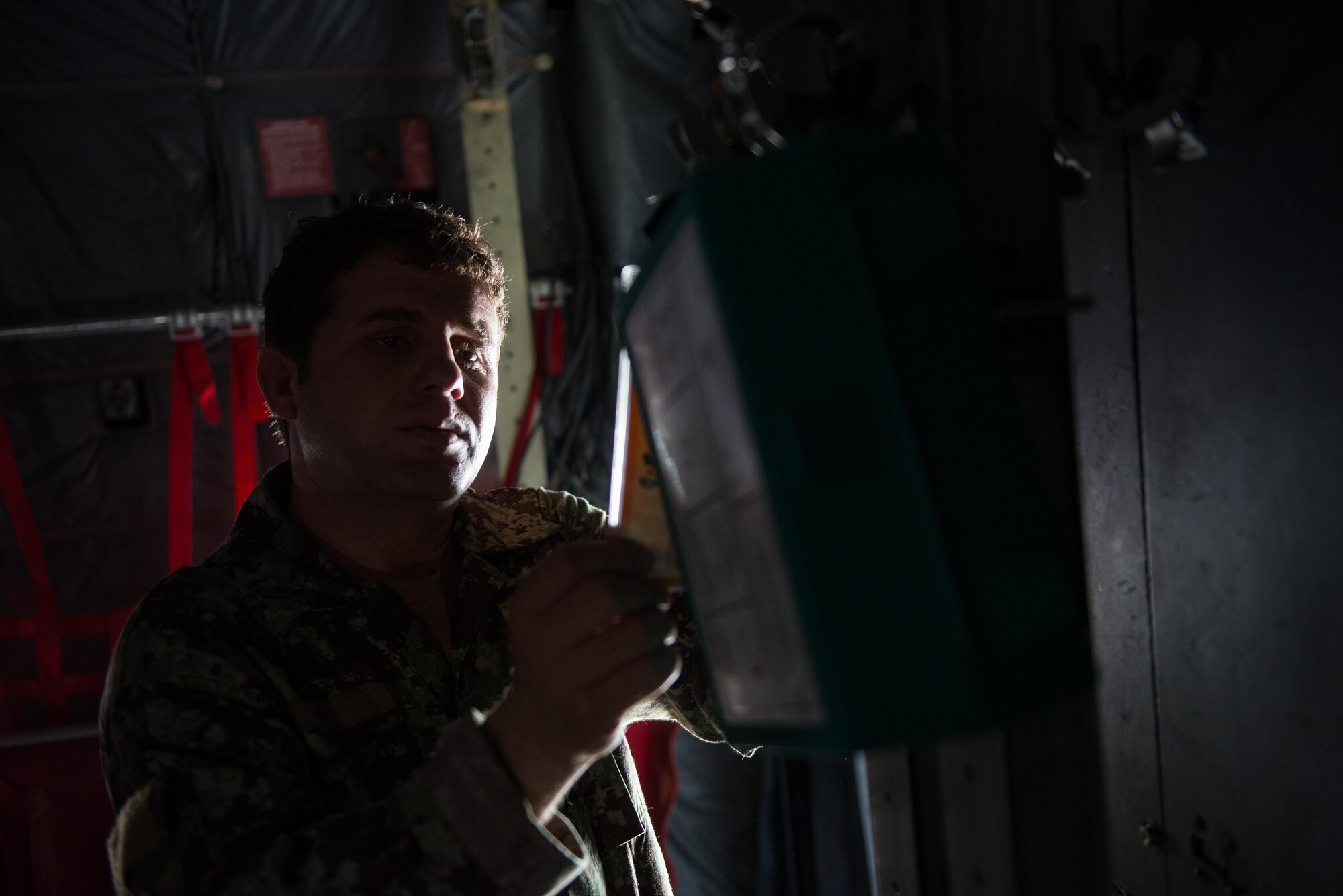 An Afghan airman inspects aircrew flight equipment aboard an Afghan C-130H Hercules aircraft during a training session with U.S. Airmen from the 455th Air Expeditionary Wing at Hamid Karzai International Airport, Kabul, Afghanistan, Aug. 29, 2015. Airmen with the 455th AEW visited Forward Operating Base Oqab and Hamid Karzai International Airport to share their aircrew flight equipment knowledge with their Afghan counterparts and also assist Train, Advice, Assist Command-Air with keeping Coalition AFE equipment current. (U.S. Air Force photo by Tech. Sgt. Joseph Swafford/Released) 
