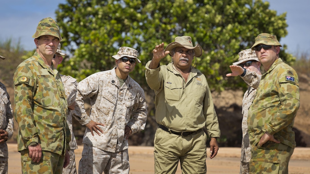 A Indigenous Larrakia Nation representative Eric Fejo (center) advises Australian Army and United States Marine Corps personnel on heritage concerns for Exercise Talisman Sabre 2015, at Fog Bay Northern Territory, Australia. Exercise Talisman Sabre is a biennial, multinational, exercise designed to enhance bilateral collaboration in support of future combined operations, natural disasters and humanitarian emergency response.