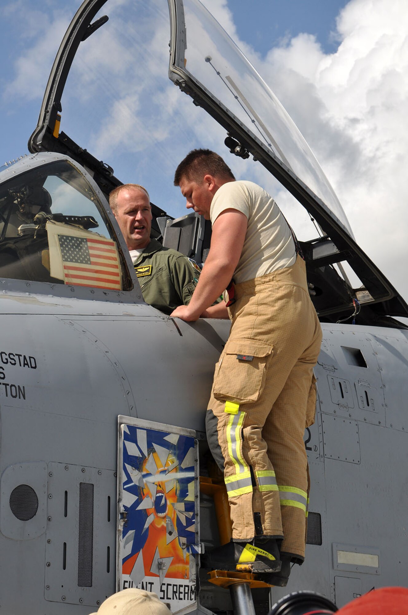 Maj. Rick Mitchell, a 303d Fighter Squadron A-10 Thunderbolt II pilot with the 442d Fighter Wing out of Whiteman Air Force Base, Mo., shows a Latvian firefighter some safety features on the A-10 Aug. 26 at Leilvarde Air Base in Latvia. Mitchell was the first U.S. fighter pilot to land a fighter jet at the airfield. The mission is part of Operation Atlantic Resolve where U.S. forces are partnering with European allies to strengthen their relationship to face potential future challenges. Latvians are learning the safety features of the A-10, how to refuel and how to handle emergencies. The 442d Fighter Wing will be part of the exercise for approximately three weeks. (U.S. Air Force photo by Capt. Denise Haeussler