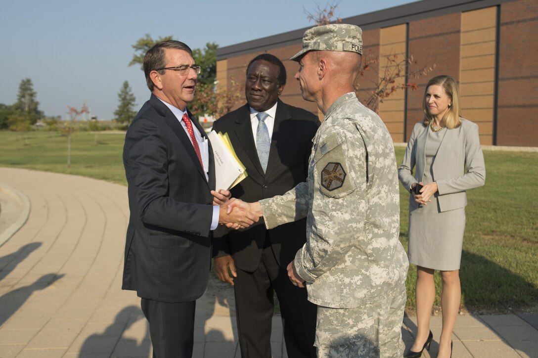 Army Col. Brian P. Foley, commander of Fort Meade Garrison, greets Defense Secretary Ash Carter as he arrives to host his first Worldwide Troop Talk on the Maryland base, Sept. 1, 2015. Ray B. Shepherd, center, director of Defense Media Activity where the event occurred, looks on. Carter answered questions from service members around the world. DoD photo by Air Force Senior Master Sgt. Adrian Cadiz