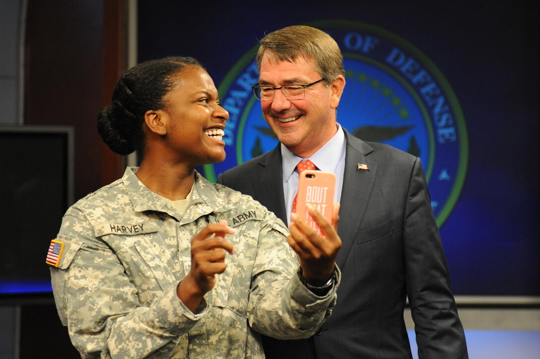 Defense Secretary Ash Carter and a military member take a selfie as he “coins” the studio audience following the Worldwide Troop Talk at the Defense Media Activity studio on Fort Meade, Md., Sept. 1, 2015. DoD photo by Marvin Lynchard