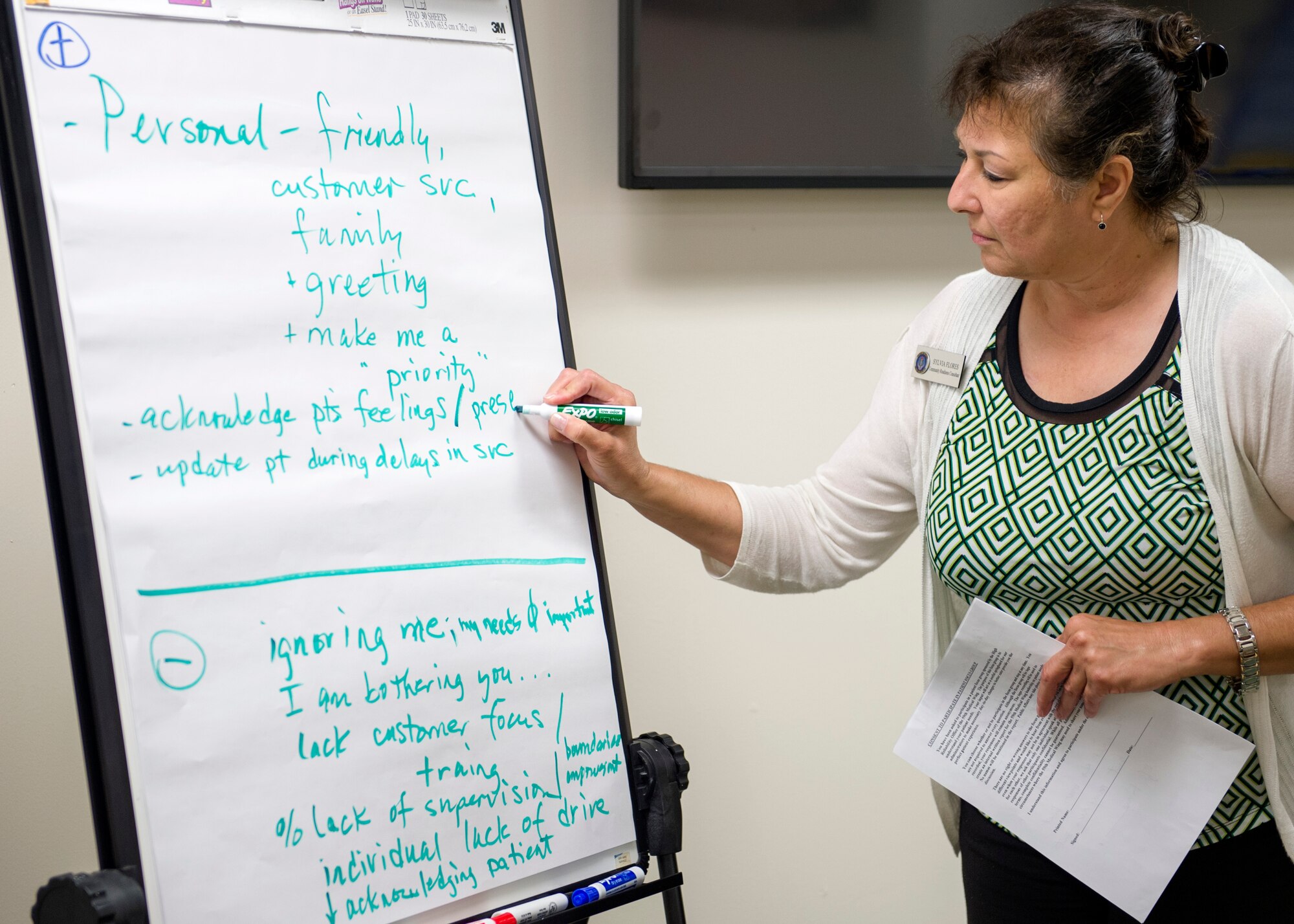 Sylvia Flores, a community readiness consultant, writes down topics during a discussion between beneficiaries participating in a 59th Medical Wing High Reliability Office focus group meeting Aug. 27, 2015, at Joint Base San Antonio-Lackland, Texas. Flores is with the Lackland Military and Family Readiness Center satellite office located at the Wilford Hall Ambulatory Surgical Center. Inputs from beneficiaries who participated in the event will help the 59th MDW enhance patient services. (U.S. Air Force Photo by Staff Sgt. Kevin Iinuma)