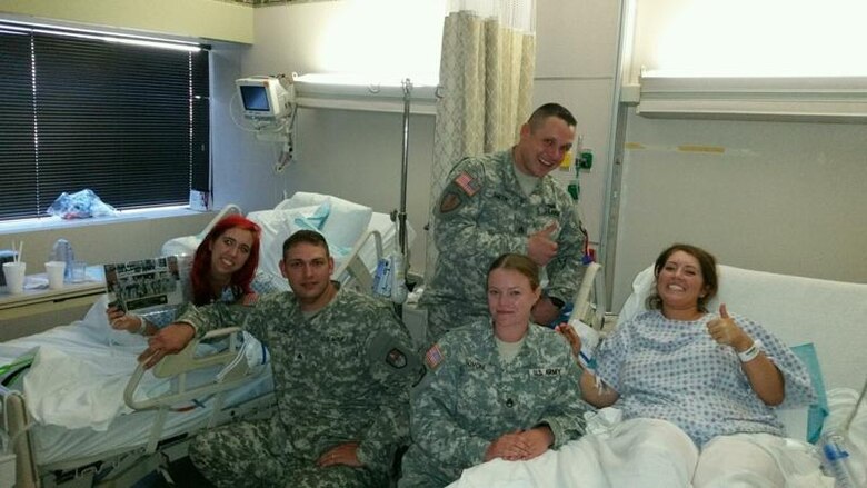 Sisters Sherrie and Melissa Snader with the Soldiers who administered first aid that saved their life Aug. 23, 2015 after the two were stabbed following a bachelorette party in Louisville, Kentucky. The first Soldier from the left, Sgt. Micah Stoke, is assigned to 4th Space Company, 1st Space Battalion, 1st Space Brigade, U.S. Army Space and Missile Defense Command/Army Forces Strategic Command, in Colorado Springs. (courtesy photo)