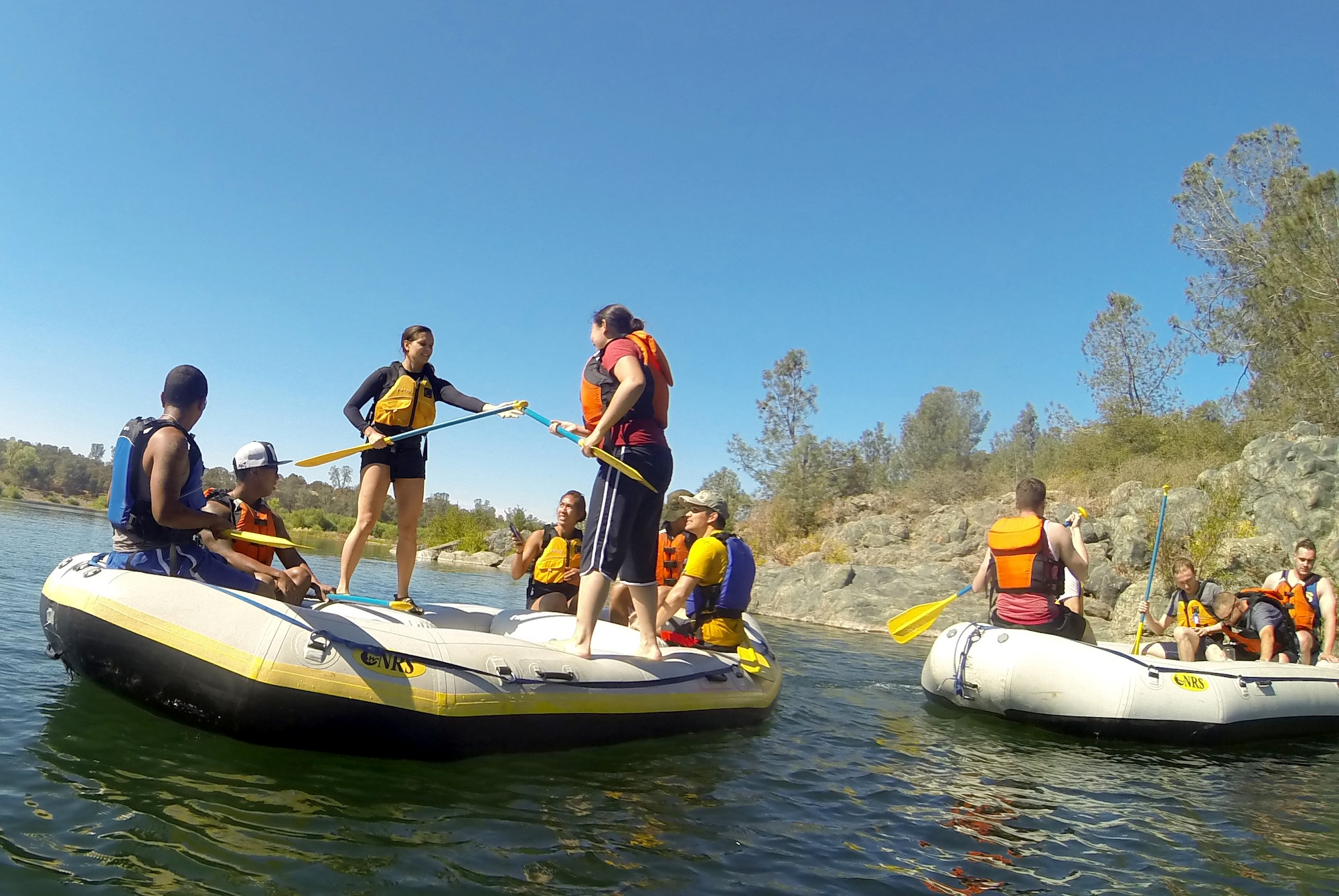 Airmen from the 13th Intelligence Squadron at Beale Air Force Base, California, practice team building exercises while floating down the Yuba River for a Comprehensive Airmen Fitness day, Aug. 26, 2015.  The CAF day focused on the social pillar and involved exercises where Airmen had to work together for balance and support. (U.S. Air Force photo by Airman 1st Class Jessica B. Nelson)