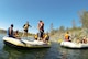 Airmen from the 13th Intelligence Squadron at Beale Air Force Base, California, practice team building exercises while floating down the Yuba River for a Comprehensive Airmen Fitness day, Aug. 26, 2015.  The CAF day focused on the social pillar and involved exercises where Airmen had to work together for balance and support. (U.S. Air Force photo by Airman 1st Class Jessica B. Nelson)