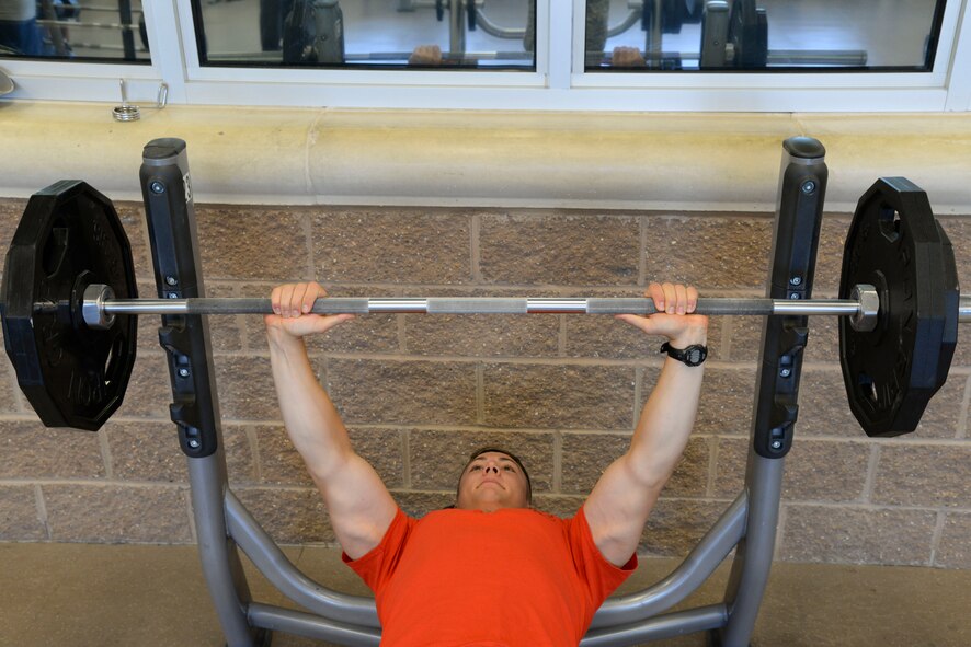 Airman 1st Class Dillon Vakoff, 96th Bomb Squadron aviation resource manager, prepares to bench press 185 pounds at the Senior Airman Bryan Bell Fitness Center at Barksdale Air Force Base, La., Aug. 31, 2015. Vakoff is the first Airman to complete the Bench a B-52 incentive program. The program was implemented by the 2nd Force Support Squadron to promote new fitness goals for Team Barksdale. (U.S. Air Force photo/Senior Airman Jannelle Dickey)