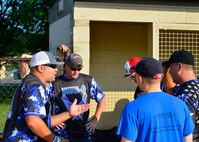 Rafael Gonzalez, 436th Security Force Squadron first baseman, motivates his team between innings during an intramural softball playoff game against the 436th Civil Engineer Squadron Aug. 24, 2015, at the softball field on Dover Air Force Base, Del. The 436th SFS were visibly frustrated after allowing the 436th CES to score six runs in first inning. (U.S. Air Force photo/Airman 1st Class William Johnson)