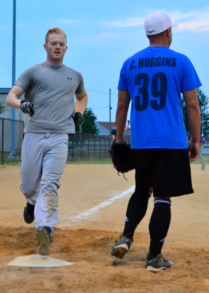 Donnie Maas, 436th Security Forces Squadron left fielder, runs through home plate scoring a run during an intramural softball playoff game against the 436th Aerial Port Squadron Aug. 18, 2015, at the softball field on Dover Air Force Base, Del. The 436th SFS won the game in the fifth inning by a mercy rule 11-1. (U.S. Air Force photo/Airman 1st Class William Johnson)