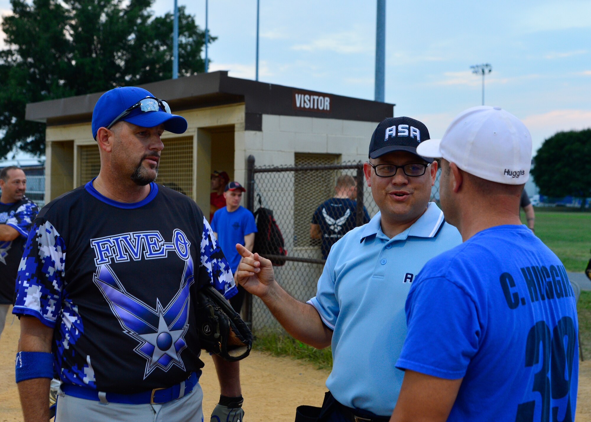 Dave Patch, Amateur Softball Association umpire, explains the rules to Rick Barker, 436th Security Force Squadron assistant coach, left, and Chad Huggins, 436th Aerial Port Squadron player-coach, right, prior to the start of an intramural softball playoff game Aug. 18, 2015, at the softball field on Dover Air Force Base, Del. The 436th SFS defeated the 436th APS 11-1 and advanced to the next round in the playoffs. (U.S. Air Force photo/Airman 1st Class William Johnson)