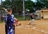 Kenneth Bancroft, 436th Security Forces Squadron player-coach, watches as one of his rookie players, Tyler Evans, 436th SFS left-center fielder, hits a softball during an intramural softball game against the 373d Training Squadron Aug. 14, 2015, at the softball field on Dover Air Force Base, Del. Evans is one of many new rookies on the 436th SFS team that won the intramural softball championship last year. (U.S. Air Force photo/Airman 1st Class William Johnson)