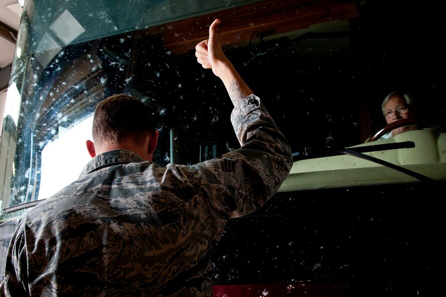 Senior Airman Jared Russell, 92nd Security Forces Squadron patrolman, ushers a vehicle forward before conducting an inspection Aug. 26, 2015, at Fairchild Air Force Base, Wash. Inspecting commercial vehicles is one of the many duties that 92nd SFS members are required to accomplish. (U.S. Air Force photo/Airman 1st Class Mackenzie Richardson)