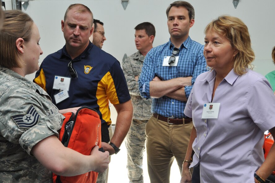 Tech. Sgt. Erin Smith, medical technician, explains to employer what kinds of supplies are available during aeromedical evacuation. Employers were invited to Peterson Air Force Base, Colo. as part of Employer Appreciation day. (U.S. Air Force photo/Capt. Cait Suttie)
