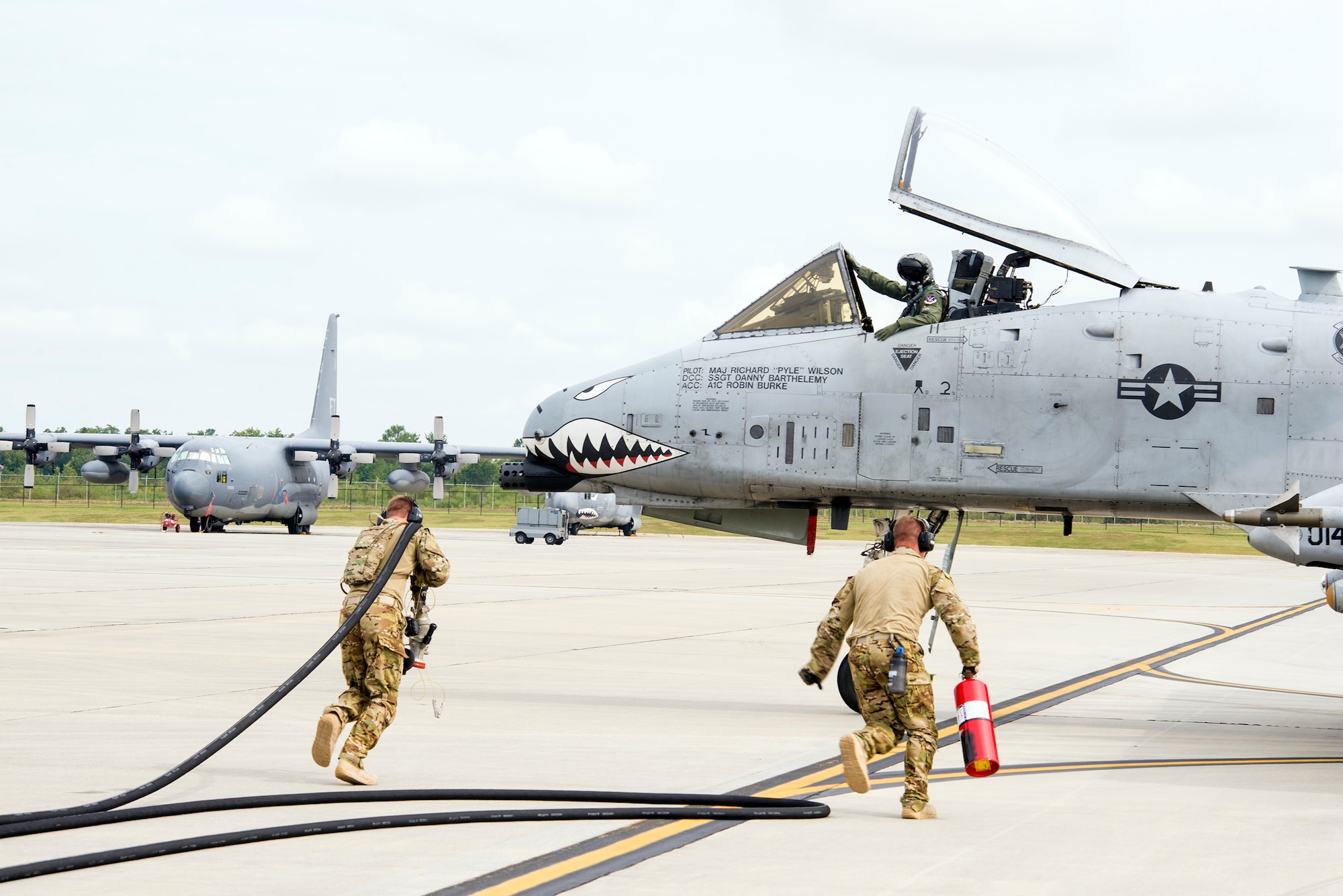 U.S. Air Force Staff Sgt. Tyler Pillmore, 23d Logistics Readiness Squadron NCO in charge of Forward Aerial Refueling Point training (left), and Senior Airman Adam Fleming, 23d LRS fuels distribution supervisor, run a fuel line hose to refuel an A-10C Thunderbolt II during FARP training Aug. 28, 2015, at Moody Air Force Base, Ga. The 23d LRS Petroleum, Oil and Lubricants flight FARP crew are responsible for refueling aircraft and disassembling the site by removing excess aircraft fuel out of fuel line hoses and running equipment back to its designated aircraft in an Air Combat Command standard of 30 minutes. (U.S. Air Force photo by Airman 1st Class Greg Nash/Released) 