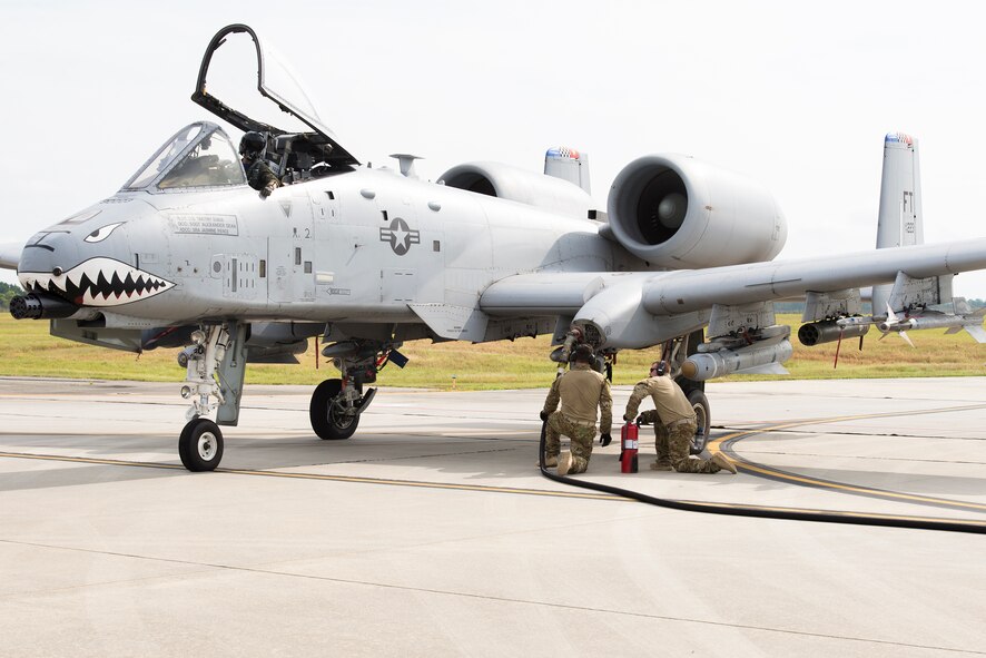 U.S. Air Force Staff Sgt. Tyler Pillmore, 23d Logistics Readiness Squadron Forward Area Refueling Point team chief (middle), and Staff Sgt. Christopher Dessi, 23d LRS NCO in charge of fuels training and support (right), refuel an A-10C Thunderbolt II during FARP training Aug. 28, 2015, at Moody Air Force Base, Ga. Moody held its first FARP training for the A-10 aircraft in preparation for the 74th Fighter Squadron’s upcoming deployment. (U.S. Air Force photo by Airman 1st Class Greg Nash/Released)