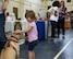 Margot LaRue, daughter of U.S. Air Force Staff Sgt. Jesse LaRue, pets a dog from a local humane society during the deployment expo in the youth center gymnasium Aug. 29, 2015 at Moody Air Force Base, Ga. There were many community services that offered information to Airmen and families ranging from the local humane society to a literacy center. (U.S. Air Force photo/Tech. Sgt. Zachary Wolf)