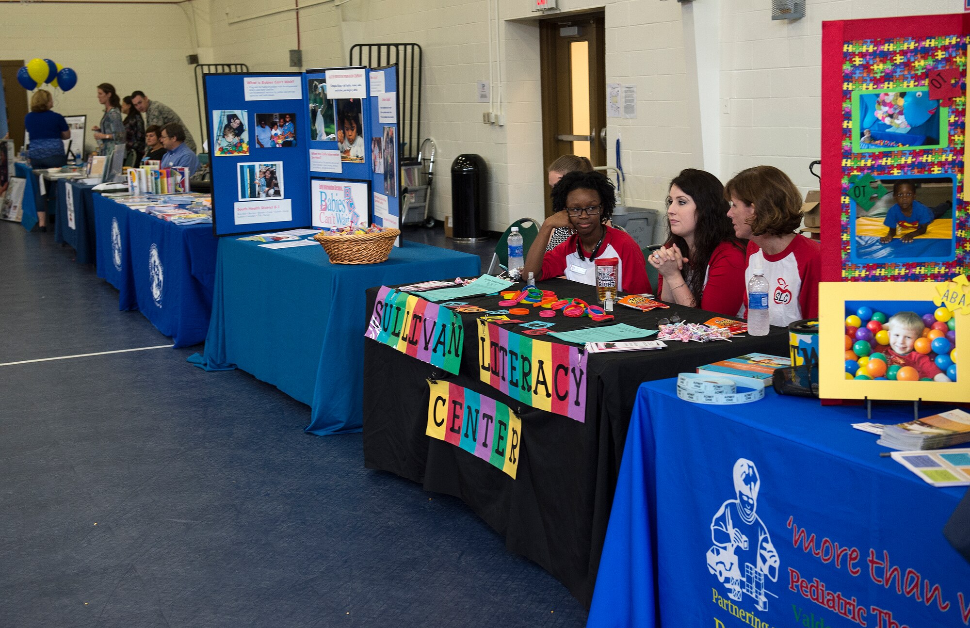 Community and base agencies fill the youth center gymnasium during the deployment expo Aug. 29, 2015 at Moody Air Force Base, Ga. More than 400 Airmen and families attended the expo to learn more about services provided as well as to participate in the family-friendly atmosphere.  (U.S. Air Force photo/Tech. Sgt. Zachary Wolf)