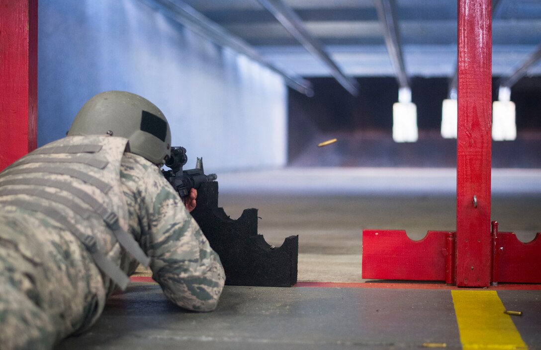 An Airman fires at his target in the prone supported position during weapons training on Joint Base Andrews, Md., Sept. 1, 2015. Airmen attend weapons training on a routine basis to maintain readiness standards. (U.S. Air Force photo by Staff Sgt. Chad C. Strohmeyer/Released)