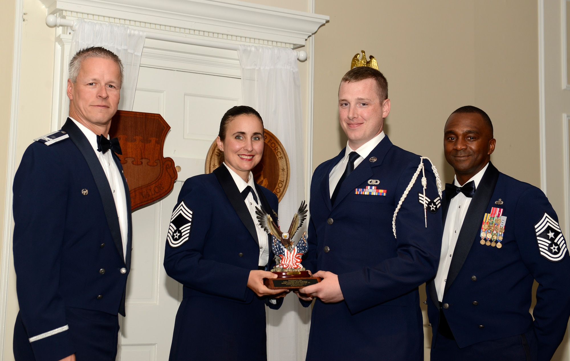 U.S. Air Force Senior Airman Joseph Sanderson, 18th Weather Squadron (right), receives the John L. Levitow Award for the Senior Master Sgt. David B. Reid Airman Leadership School Class 15-6, from Chief Master Sgt. Summer Leifer,  U.S. Air Forces Central intelligence directorate  chief enlisted manager, and 20th Fighter Wing leadership, at Shaw Air Force Base, S.C., May 15, 2014. The Levitow Award is given to the graduate with the highest average of instructor and student points, and is the highest award in enlisted professional military education. (U.S. Air Force photo by Airman 1st Class Christopher Maldonado/Released)