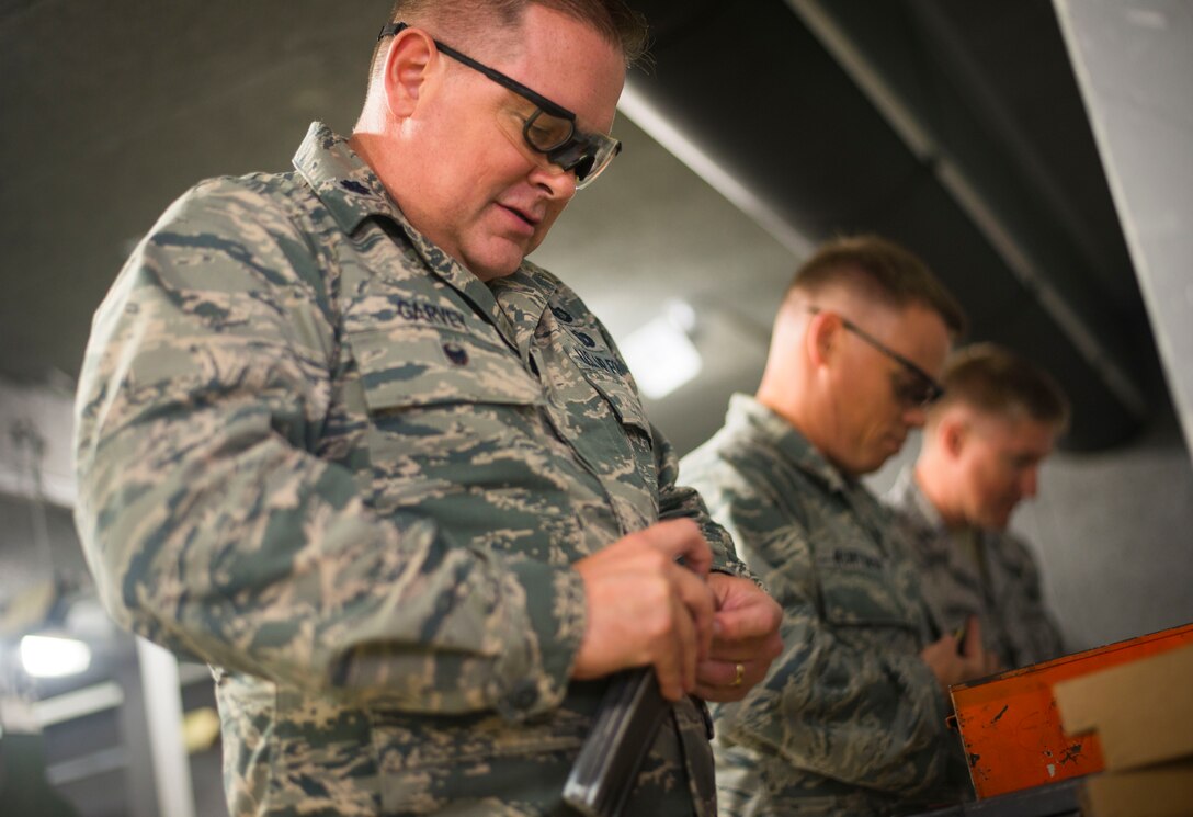Lt. Col. James Garvey, Air National Guard Readiness Center chief of budget support, loads 5.56 mm rounds in to an M4 Carbine magazine prior to weapons training on Joint Base Andrews, Md., Sept. 1, 2015. Airmen attend weapons training on a routine basis to maintain readiness standards. (U.S. Air Force photo by Staff Sgt. Chad C. Strohmeyer/Released)