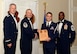U.S. Air Force Senior Airman Andrew Kulbiski, 31st Intelligence Squadron (right), receives a distinguished graduate award for Class 15-6 of the Senior Master Sgt. David B. Reid Airman Leadership School from Master Sgt. Gregory Spiczka, 20th Security Forces Squadron first sergeant, and 20th Fighter Wing leadership, at Shaw Air Force Base, S.C., Aug. 27, 2015. The distinguished graduate awards are given to the top 10 percent of the class for total point accumulation. (U.S. Air Force photo by Airman 1st Class Christopher Maldonado/Released)