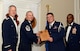 U.S. Air Force Senior Airman John Miller, 31st Intelligence Squadron (right), receives a distinguished graduate award for Class 15-6 of the Senior Master Sgt. David B. Reid Airman Leadership School from Master Sgt. Gregory Spiczka, 20th Security Forces Squadron first sergeant, and 20th Fighter Wing leadership at Shaw Air Force Base, S.C., Aug. 27, 2015. The distinguished graduate awards are given out to the top 10 percent of the class for total point accumulation. (U.S. Air Force photo by Airman 1st Class Christopher Maldonado/Released)