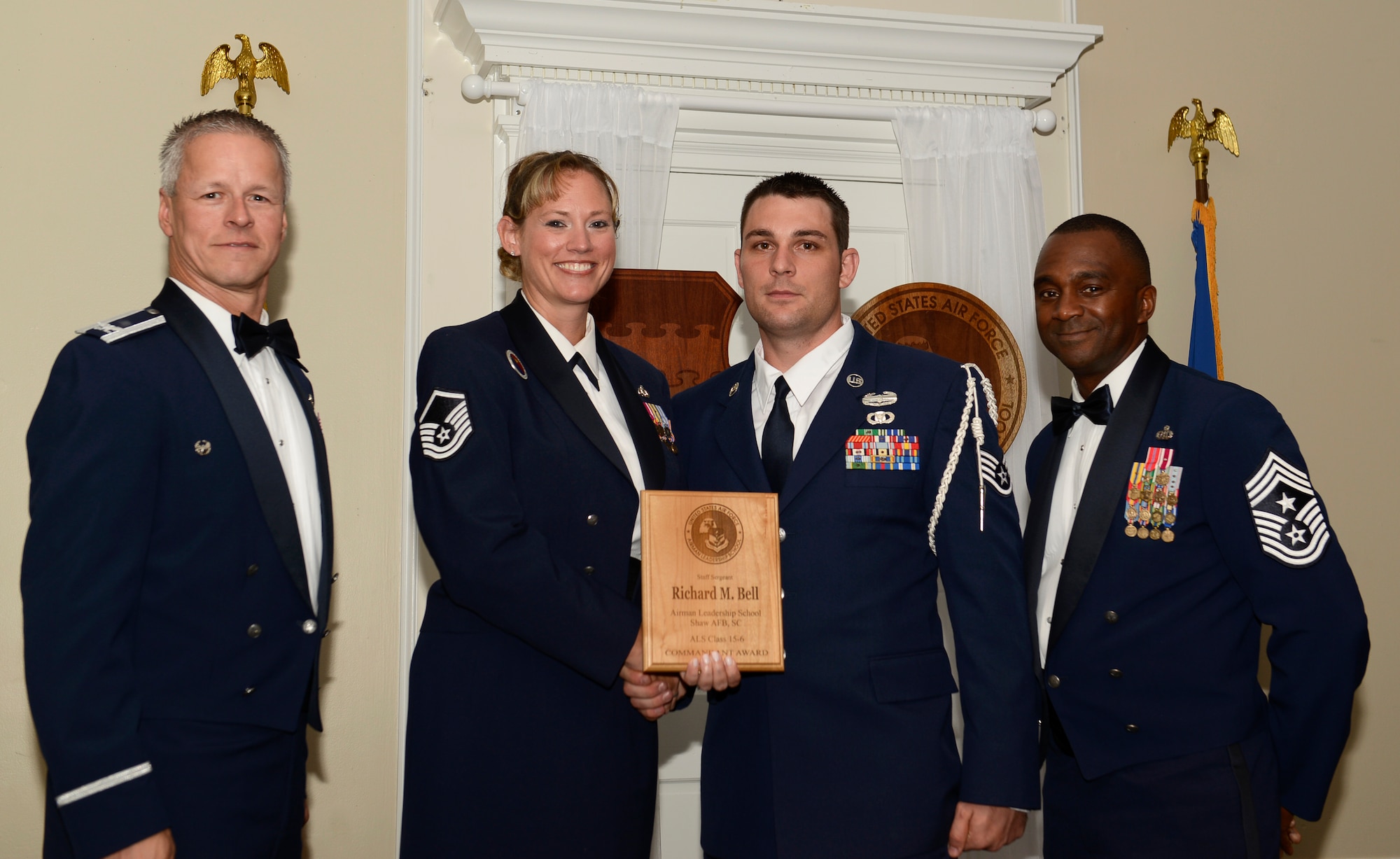 U.S. Air Force Staff Sgt. Richard Bell, 20th Air Support Operations Squadron (right), receives the Senior Master Sgt. David B. Reid Airman Leadership School Commandant’s Award for Class 15-6 from Master Sgt. Lindsey Wolf, 20th Force Support Squadron ALS commandant and 20th Fighter Wing leadership, at Shaw Air Force Base, S.C., Aug. 27, 2015. The Commandant’s Award is given to the student who most exemplifies professional military qualities as chosen by their peers, the primary instructors, and the ALS commandant. (U.S. Air Force photo by Airman 1st Class Christopher Maldonado/Released)