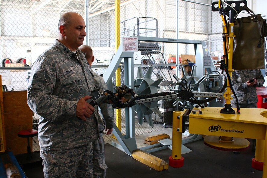 WRIGHT-PATTERSON AIR FORCE BASE, Ohio -- Maj. Gen. Richard S. Haddad, Air Force Reserve Command vice commander, Robins Air Force Base, Georgia, tests the Ingersoll Rand Ergonomic Handling System during his visit to the 445th Maintenance Squadron August 27, 2015. This in-house initiative put in place an ergonomic lifting device with a floating load unit, which aids picking, lifting, and moving of the C-17 Globemaster III wheels. This process improvement greatly reduces the risks of manual lifting injuries long associated with this repair process. Maj. Gen. Haddad, Maj. Gen. Kenneth D. Lewis, Director of Air, Space and Information Operations, Air Force Reserve Command, Robins Air Force Base Georgia and Maj. Gen. Brian E. Dominguez, Mobilization Assistant to the Commander, Air Mobility Command, Scott Air Force Base, Illinois were visiting the wing as one of their stops to discuss process improvement and provide crosstalk for other units and future implementation across the command. (U.S. Air Force photo/Tech. Sgt. Patrick O’Reilly)